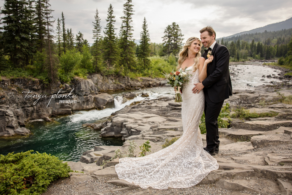 Wedding couple by mountain stream